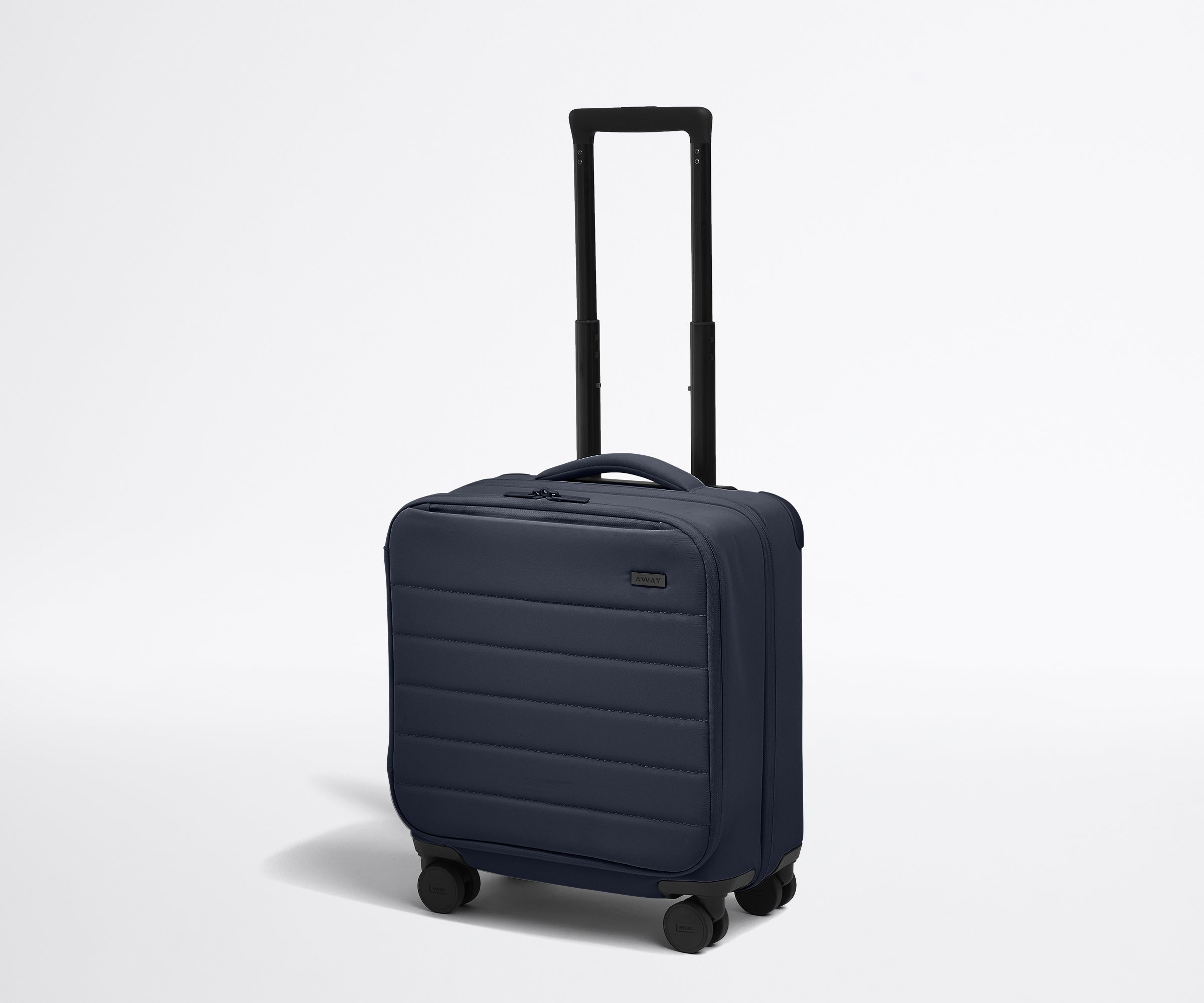 Angled product view of The Softside Compact Carry-On suitcase in Navy Blue with raised handle