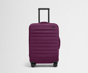 Front product view of The Softside Bigger Carry-On suitcase in Plum Purple with raised handle