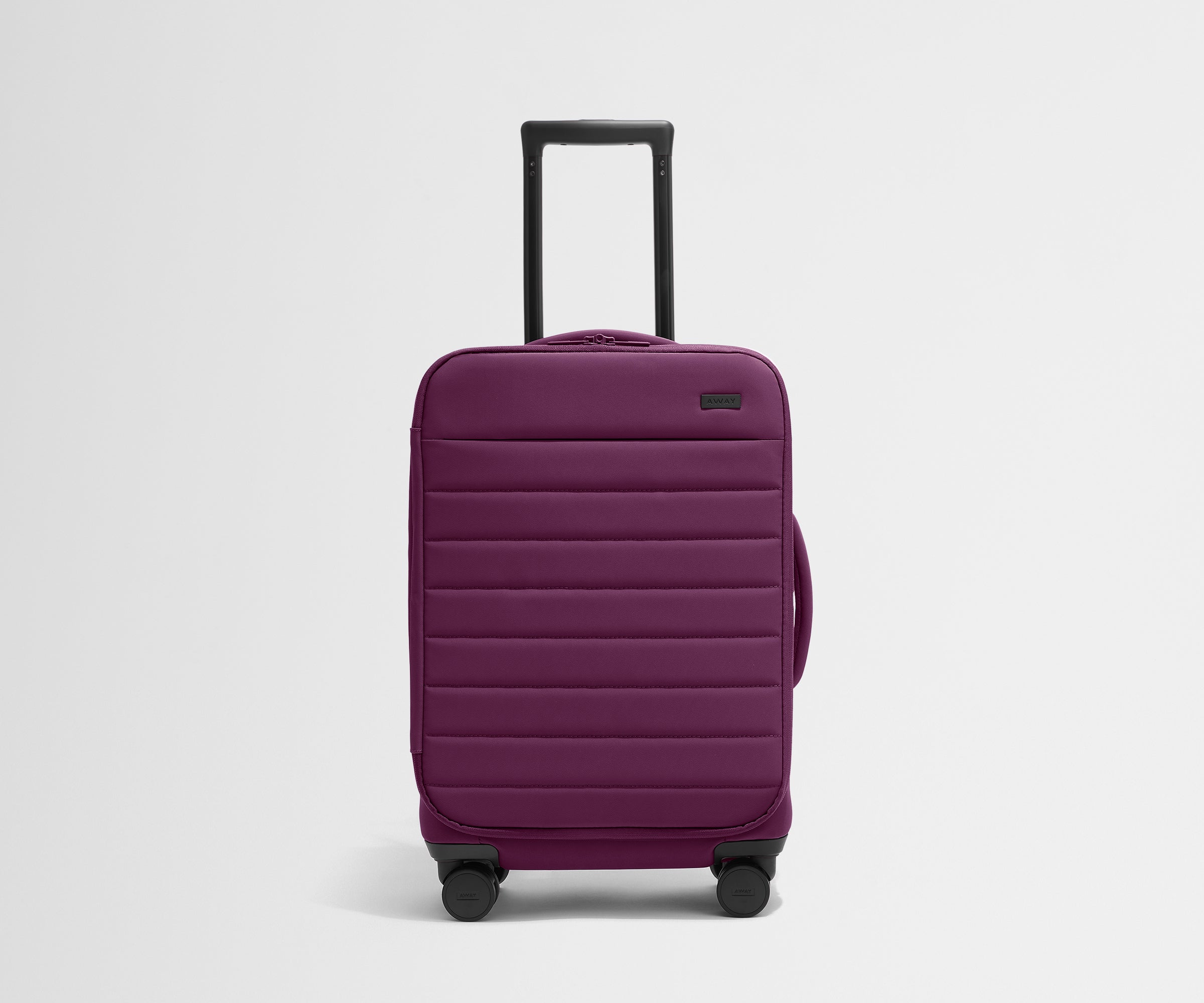 Front product view of The Softside Carry-On suitcase in Plum Purple with raised handle