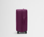 Side product view of The Softside Large suitcase in Plum Purple shown fully expanded