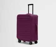 Angled product view of The Softside Medium suitcase in Plum Purple with raised handle