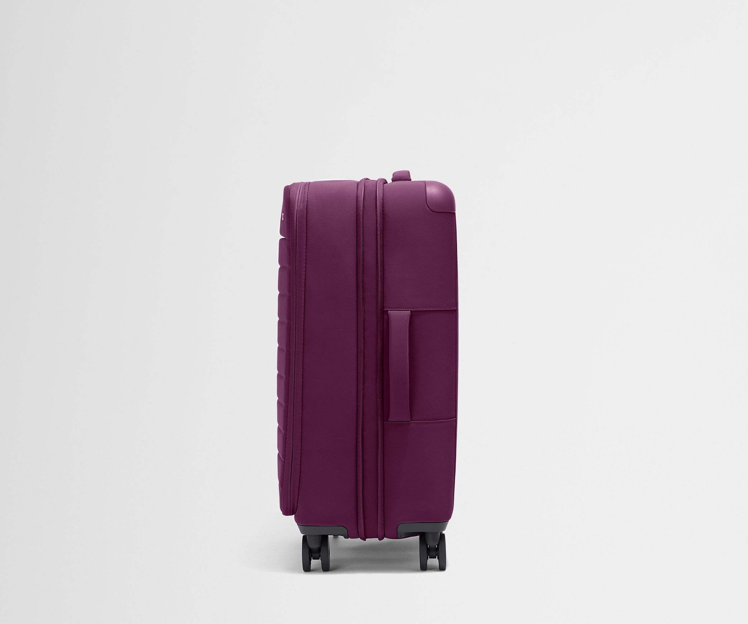 Side product view of The Softside Medium suitcase in Plum Purple shown fully expanded
