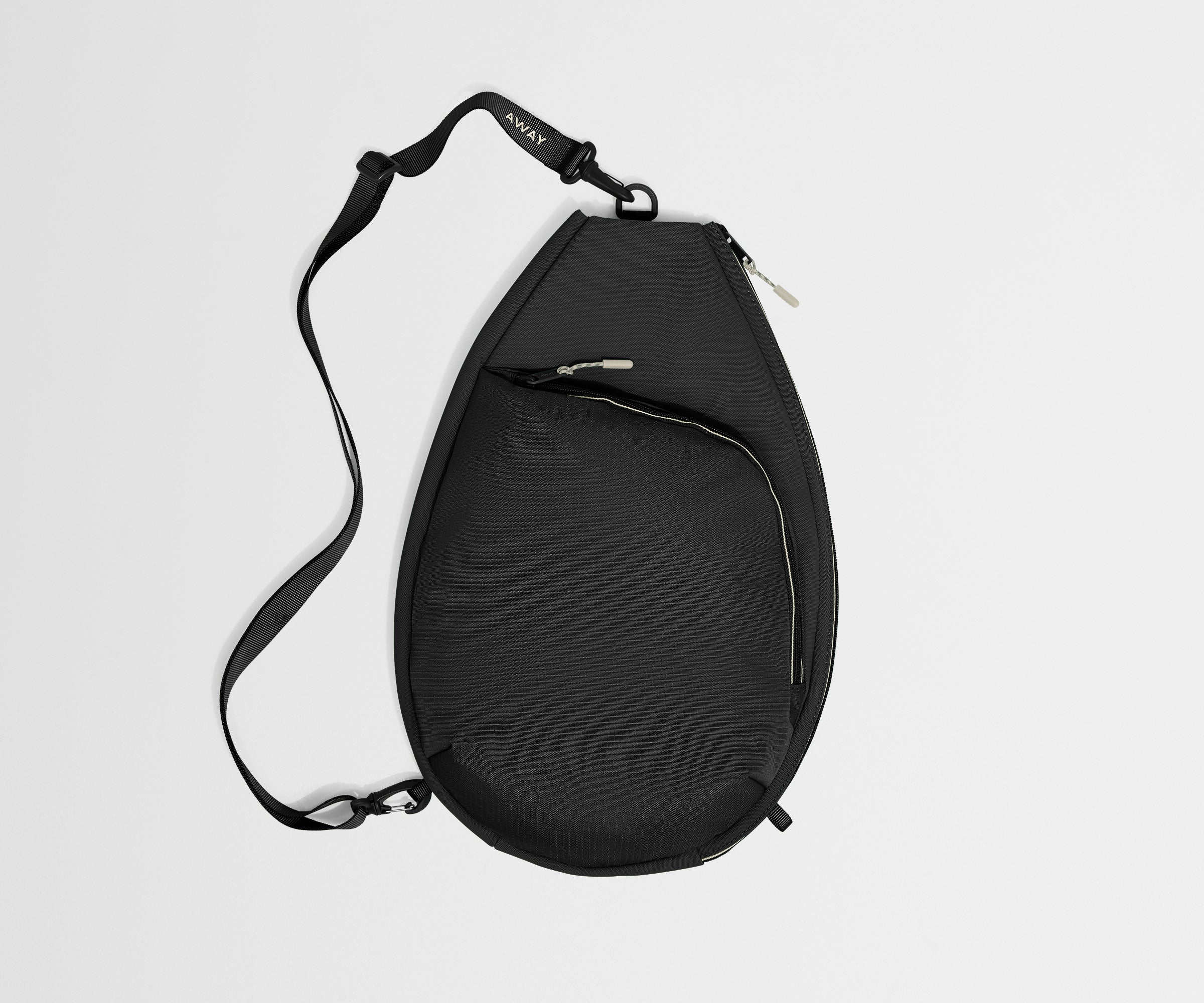 Black sling bag on a light gray background