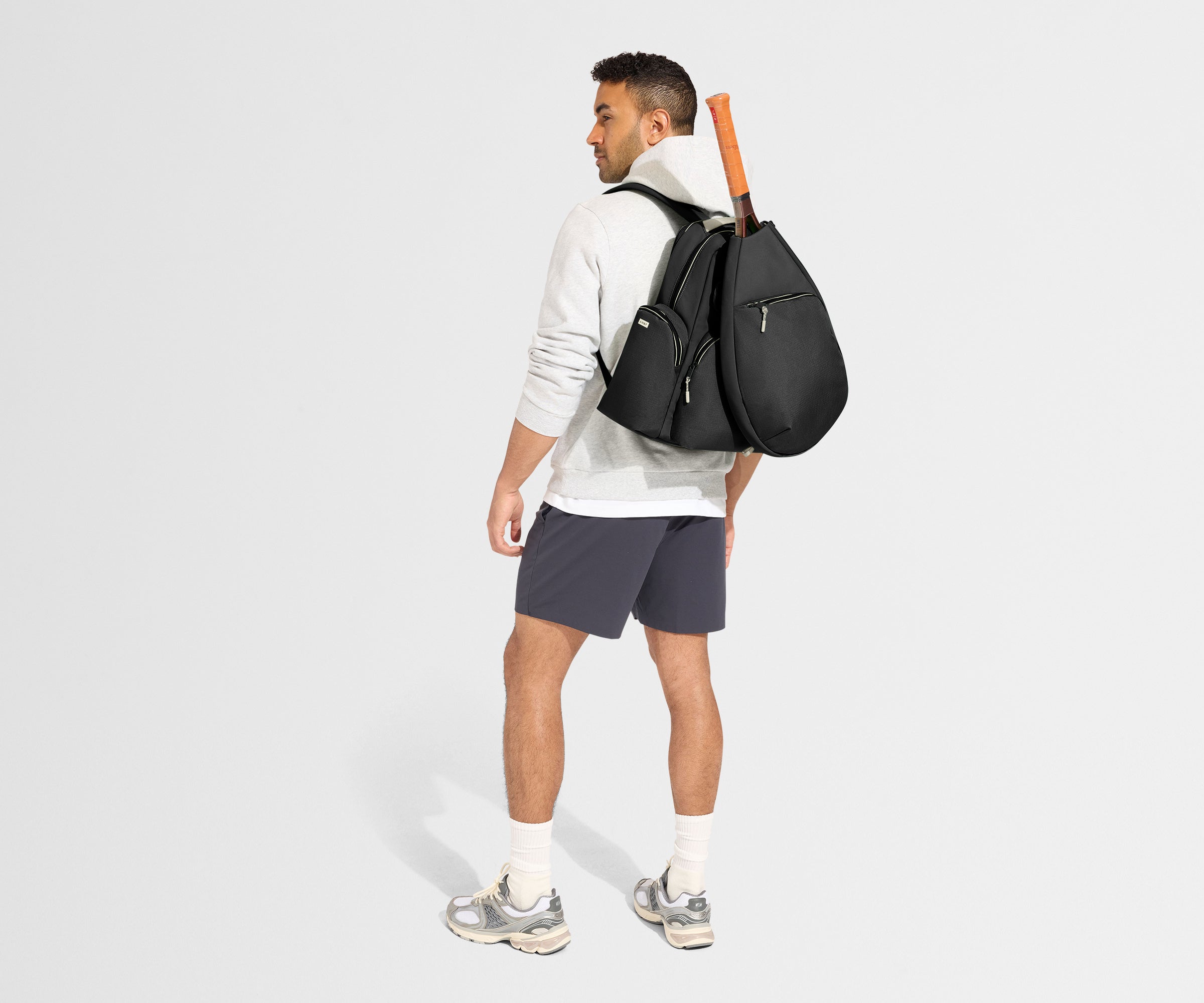 //
Model is 6'1", wearing the Sport Backpack with the Racket Bag attached.