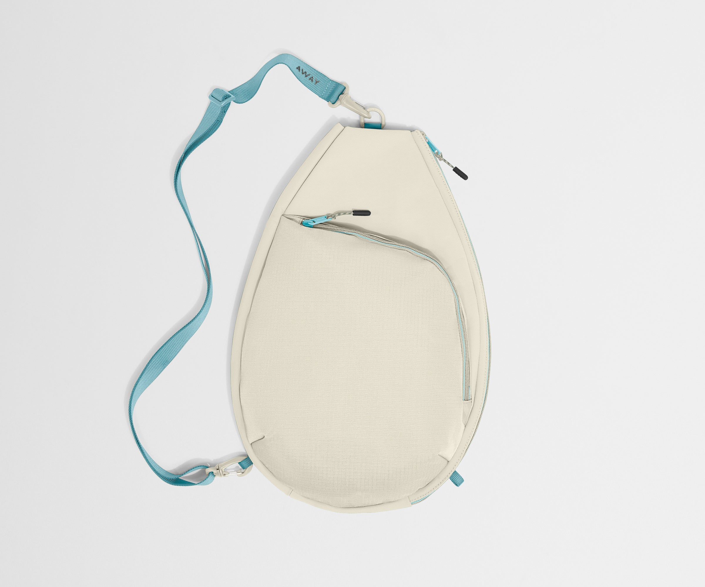 Beige racket bag with a blue strap on a light gray background