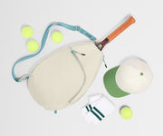 Paddle, paddle cover, and tennis balls on a white background