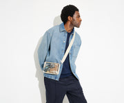 The clear Stadium Bag worn crossbody on male talent, letting her be hands free, and showing how clear the bag so it meets stadium and venue regulations