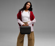 Person carrying the Train Case by its top handle