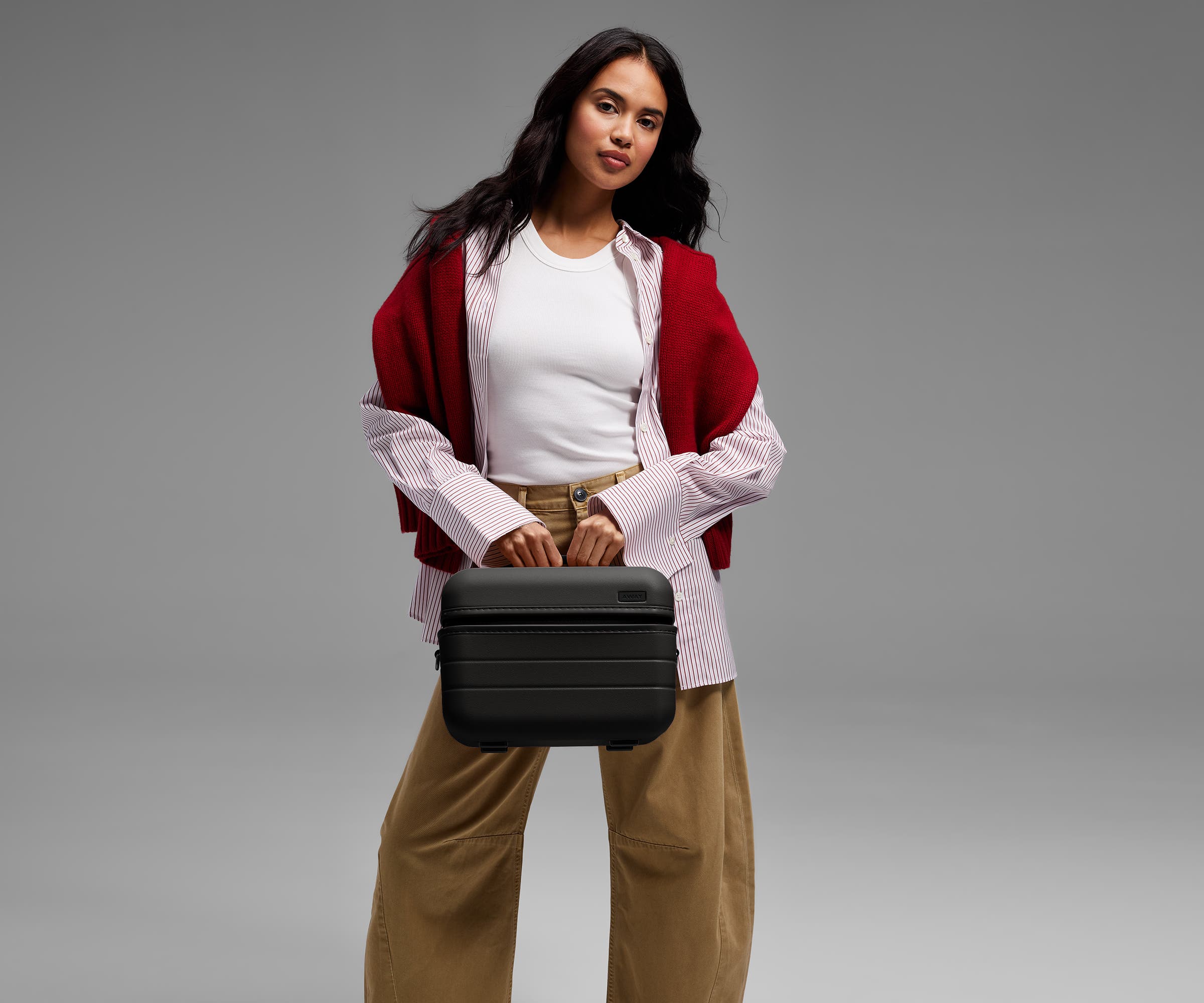 Person carrying the Train Case by its top handle