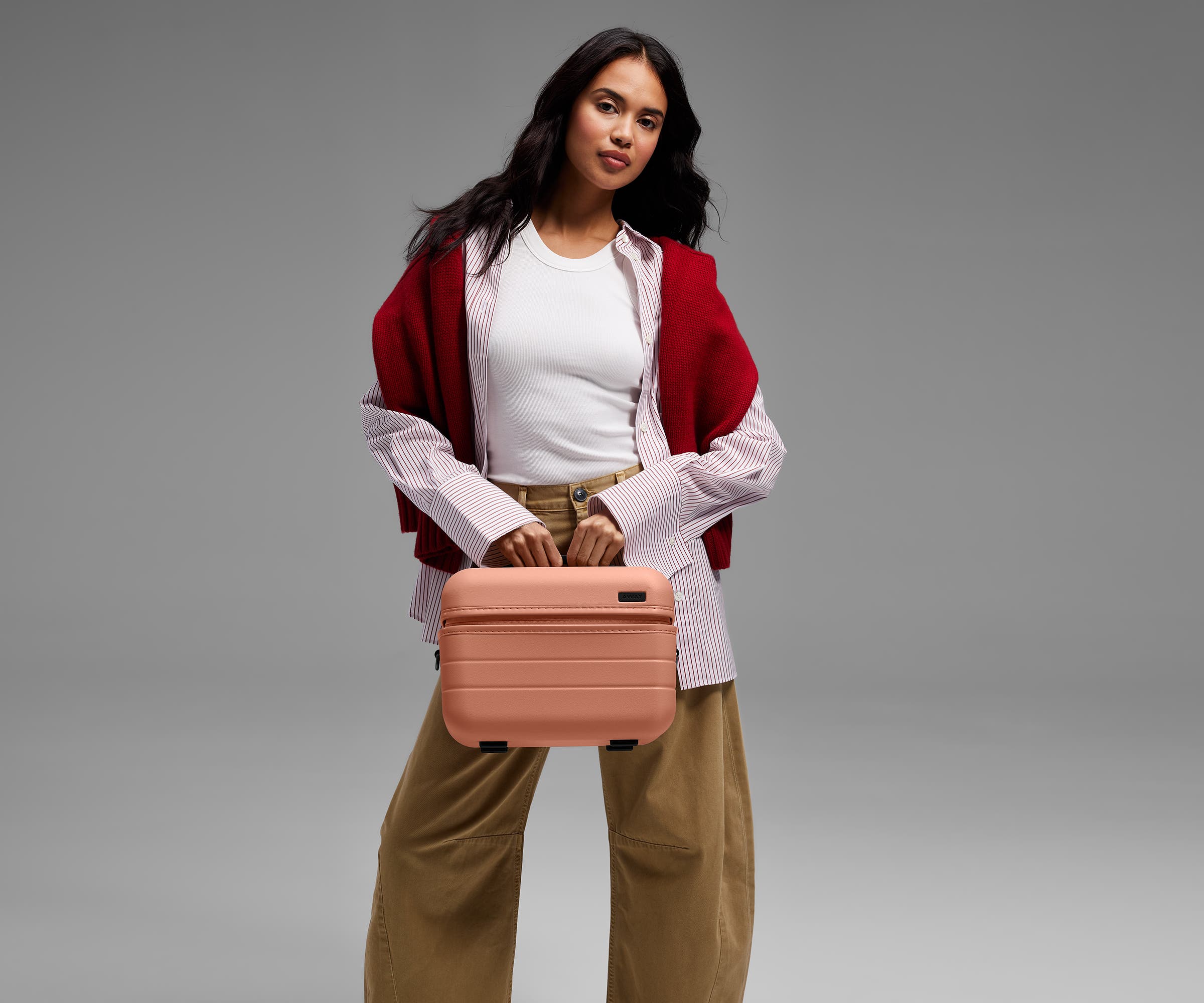 Person carrying the Train Case by its top handle