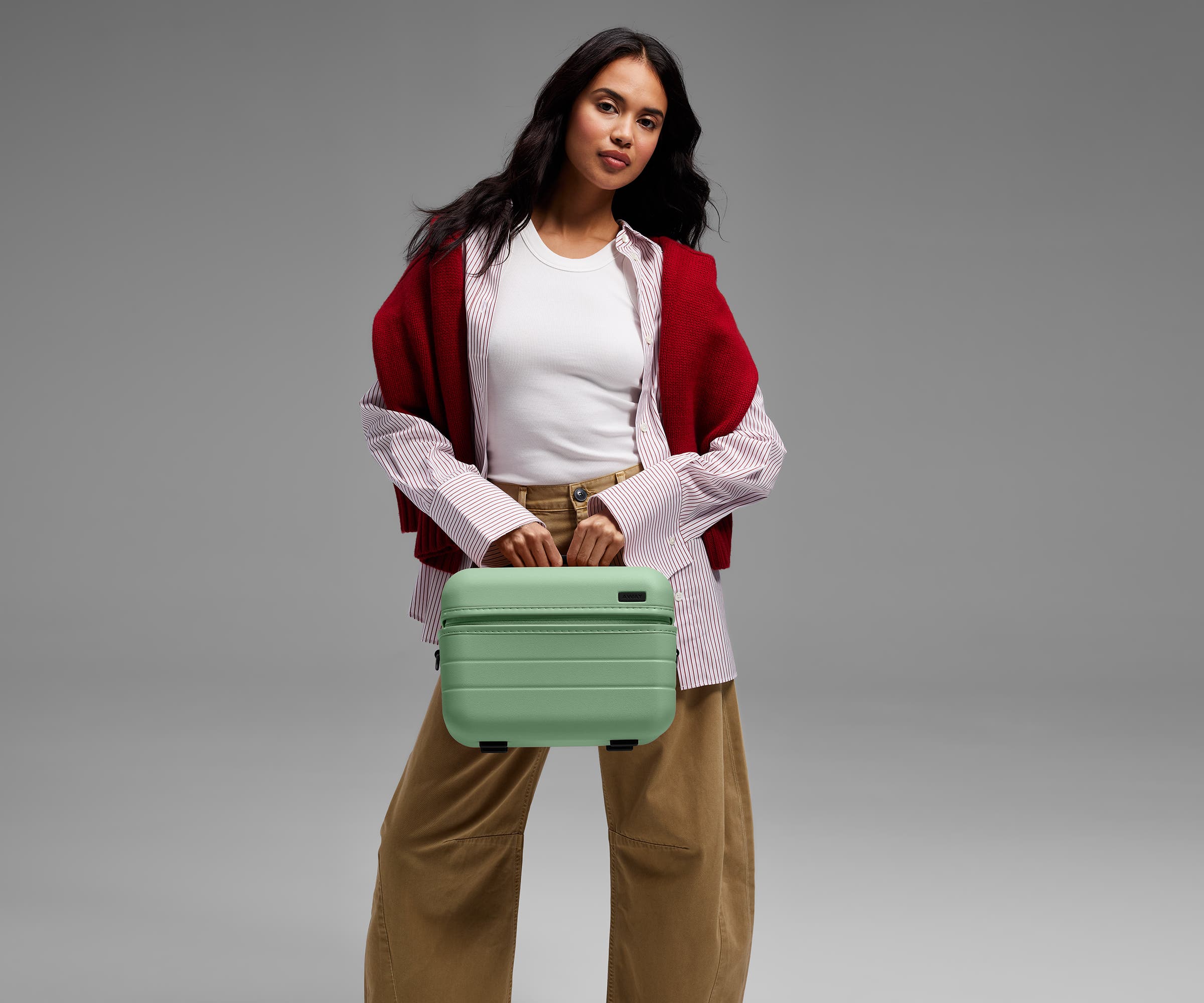 Person carrying the Train Case by its top handle