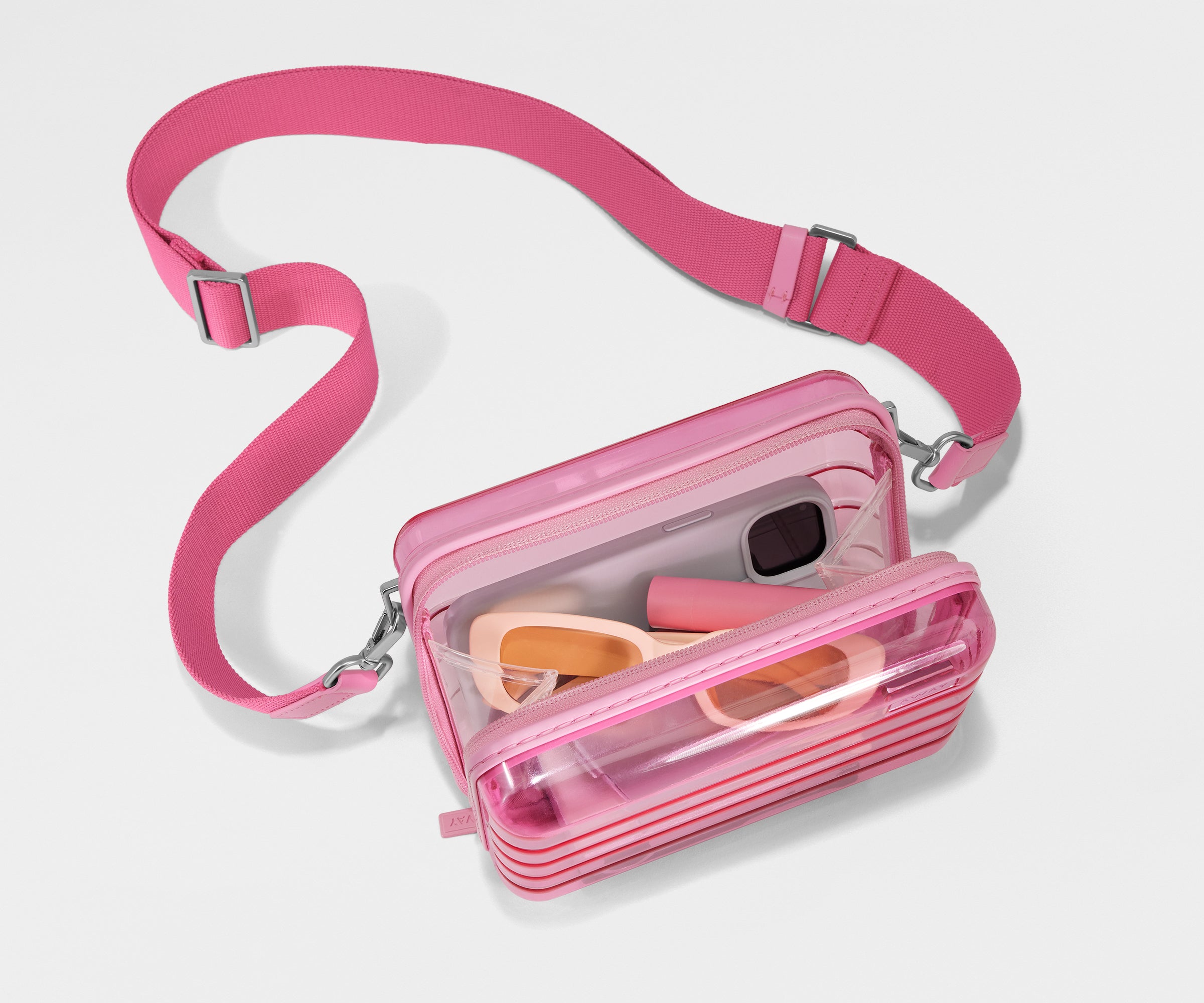 The Mini Crossbody packed with a phone, passport, and sunglasses