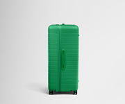 Side product view of The Trunk suitcase in Palm Green to show the slimmer top lid and deeper main compartment for easy access and packing