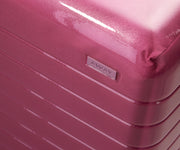Zoomed in product view of The Carry-On suitcase in Translucent Pink to show the semi-transparent shell and opaque, color-matched interior lining