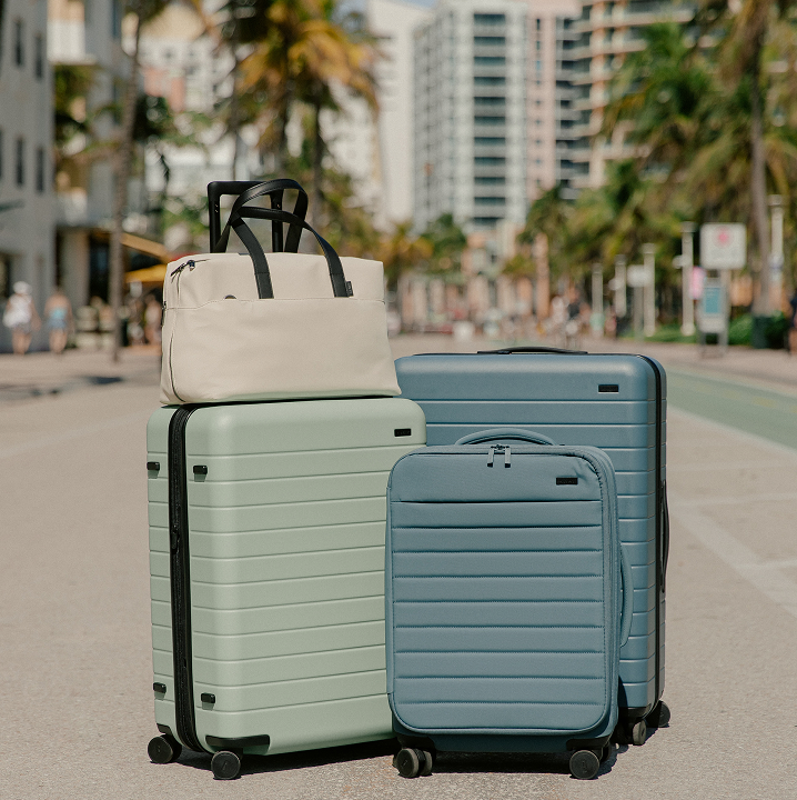 Photo of multiple Away luggages and an Away everywhere bag in the city