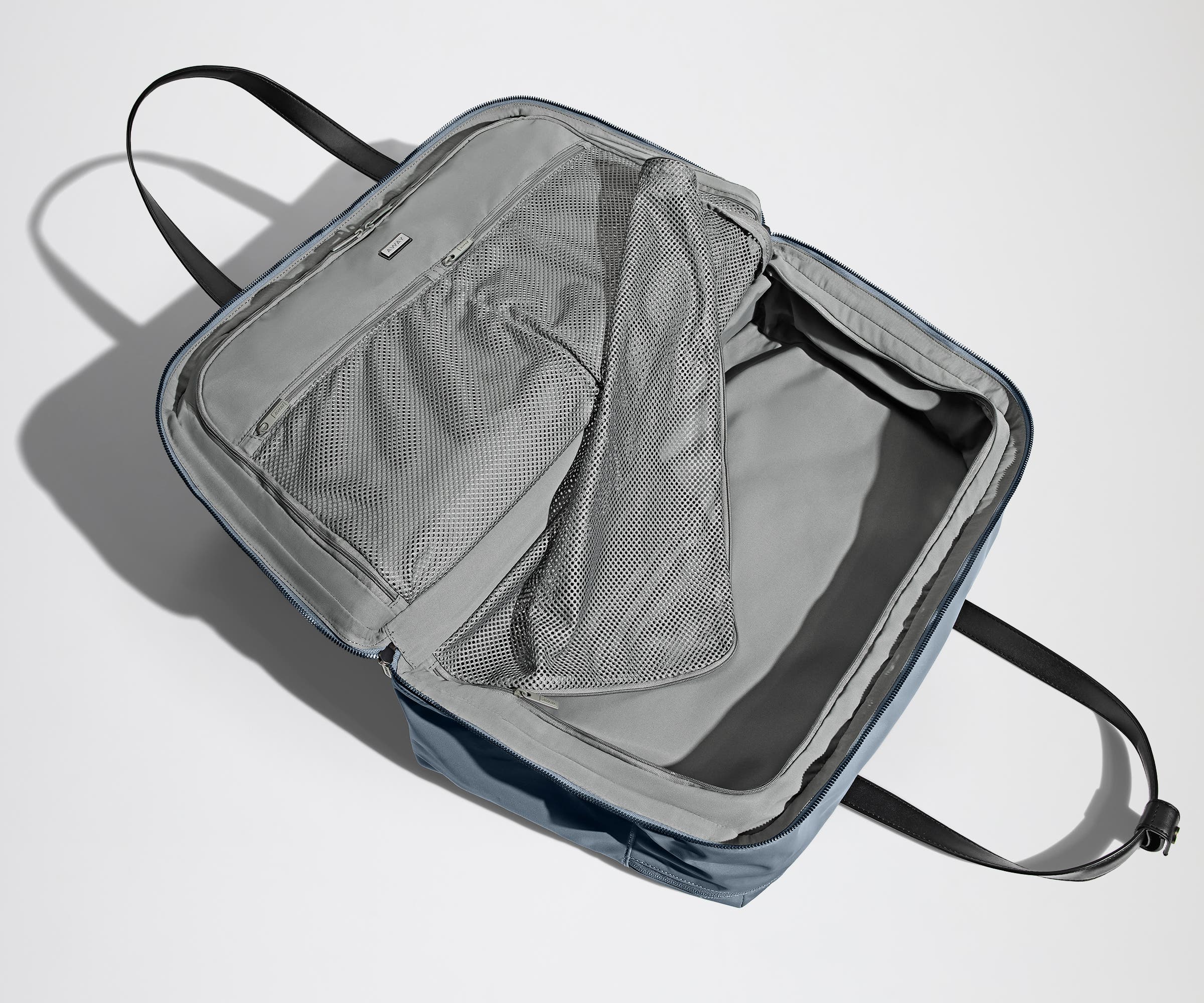 Open, unpacked Weekender Bag showing the mesh compartments and pockets