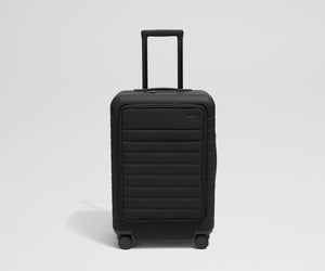 Front product view of The Front Pocket Bigger Carry-On suitcase in Jet Black with raised handle