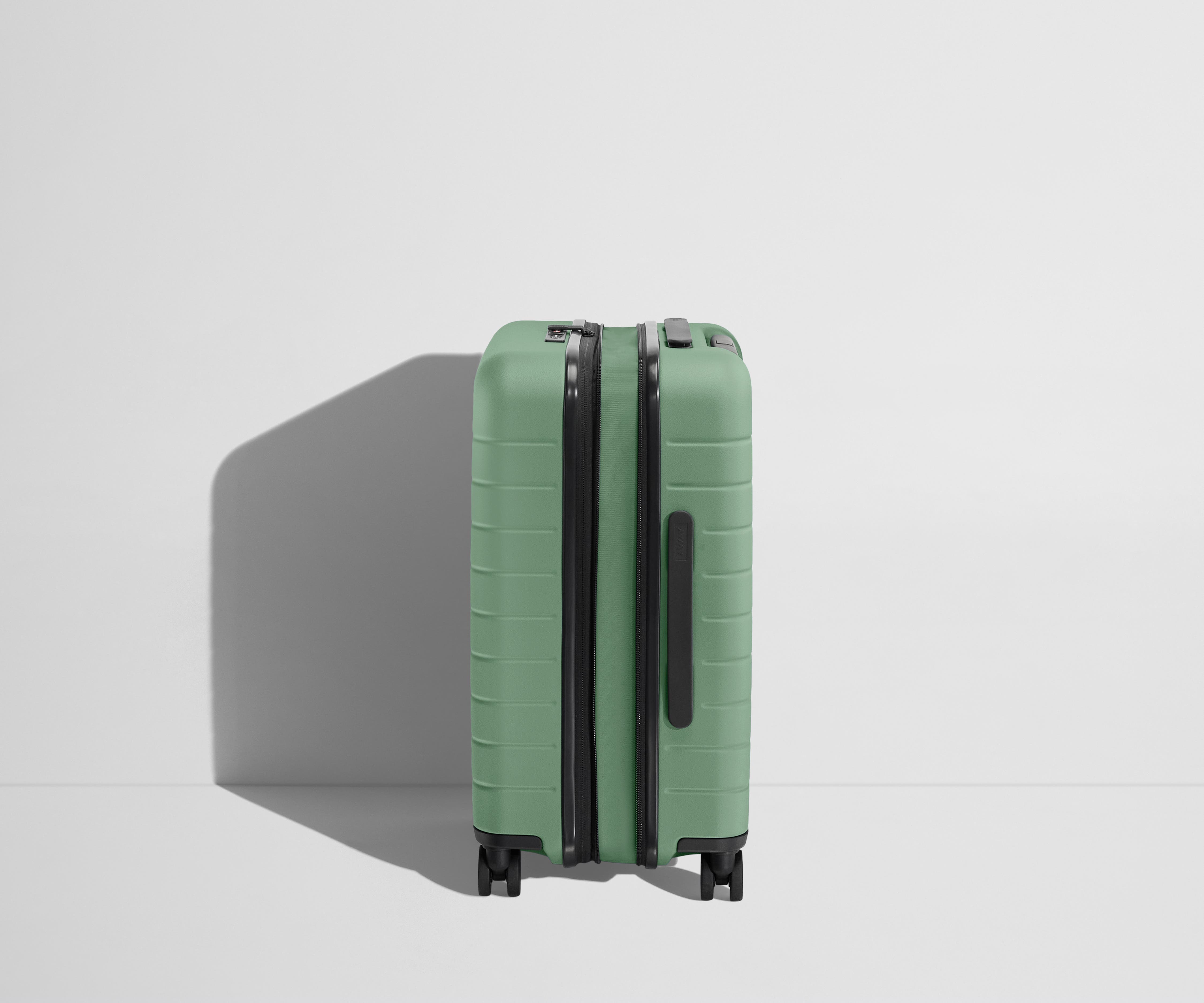 Side product view of The Carry-On Flex suitcase in Sea Green shown fully expanded