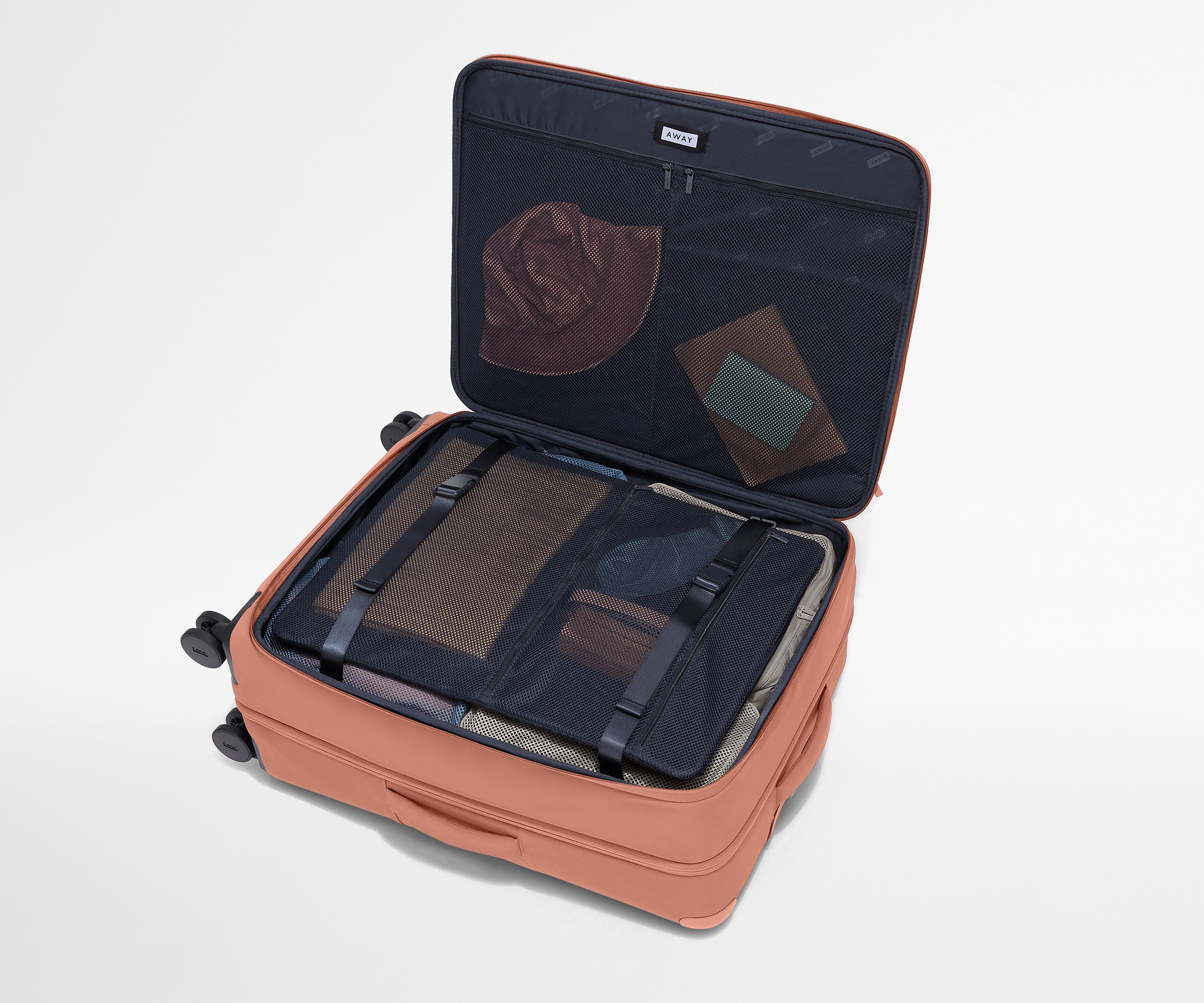 Open Softside suitcase, with travel essentials in the front flap pocket and compression pad pockets