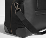 Detailed view of the canvas and leather material, including the removable shoulder strap