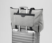Transit Canvas Tote on top of an Away aluminum suitcase