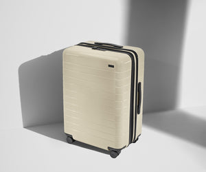 Angled product view of The Medium Flex suitcase in Salt White (Gloss)