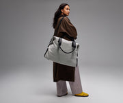 Person wearing the Transit Canvas Weekender by its removable shoulder strap