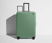 Front product view of The Large suitcase in Sea Green with raised handle