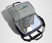 Main interior packed with clothing. Slip pockets packed with a notebook and charging cords
