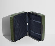 The Medium suitcase in Olive Green shown open in an upright position to show interior organization and compression system