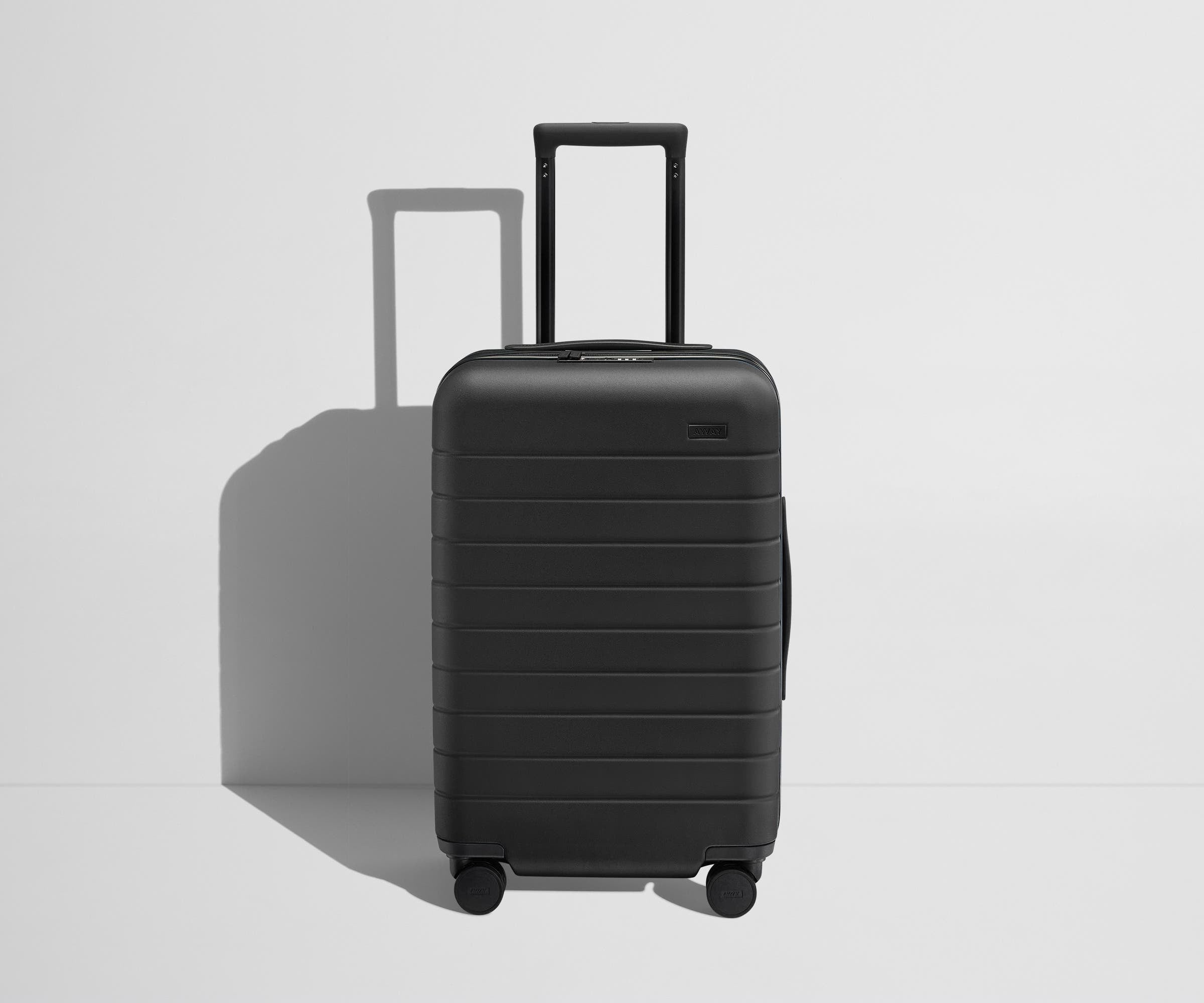 Front product view of The Carry-On Flex suitcase in Jet Black with raised handle