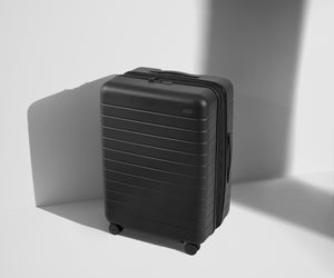 Angled product view of The Medium Flex suitcase in Jet Black