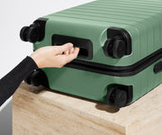 The Carry-On suitcase in Sea Green shown from below highlighting the underside grab handle