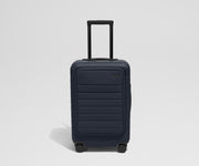 Front product view of The Front Pocket Carry-On suitcase in Navy Blue with raised handle