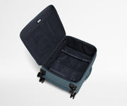 Open, unpacked Softside Medium suitcase, showing the depth of the bag and signature compression pad feature