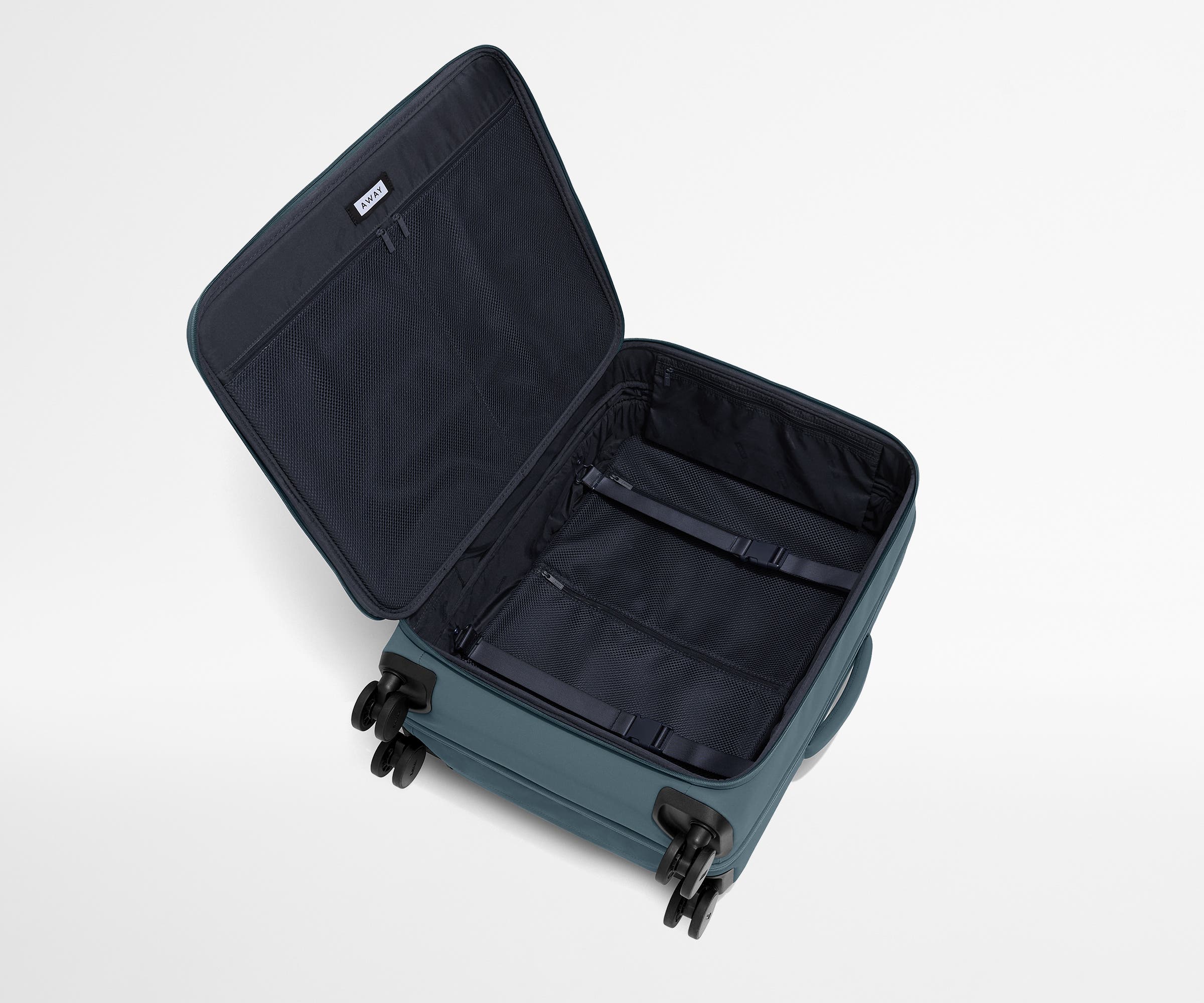 Open, unpacked Softside Medium suitcase, showing the depth of the bag and signature compression pad feature