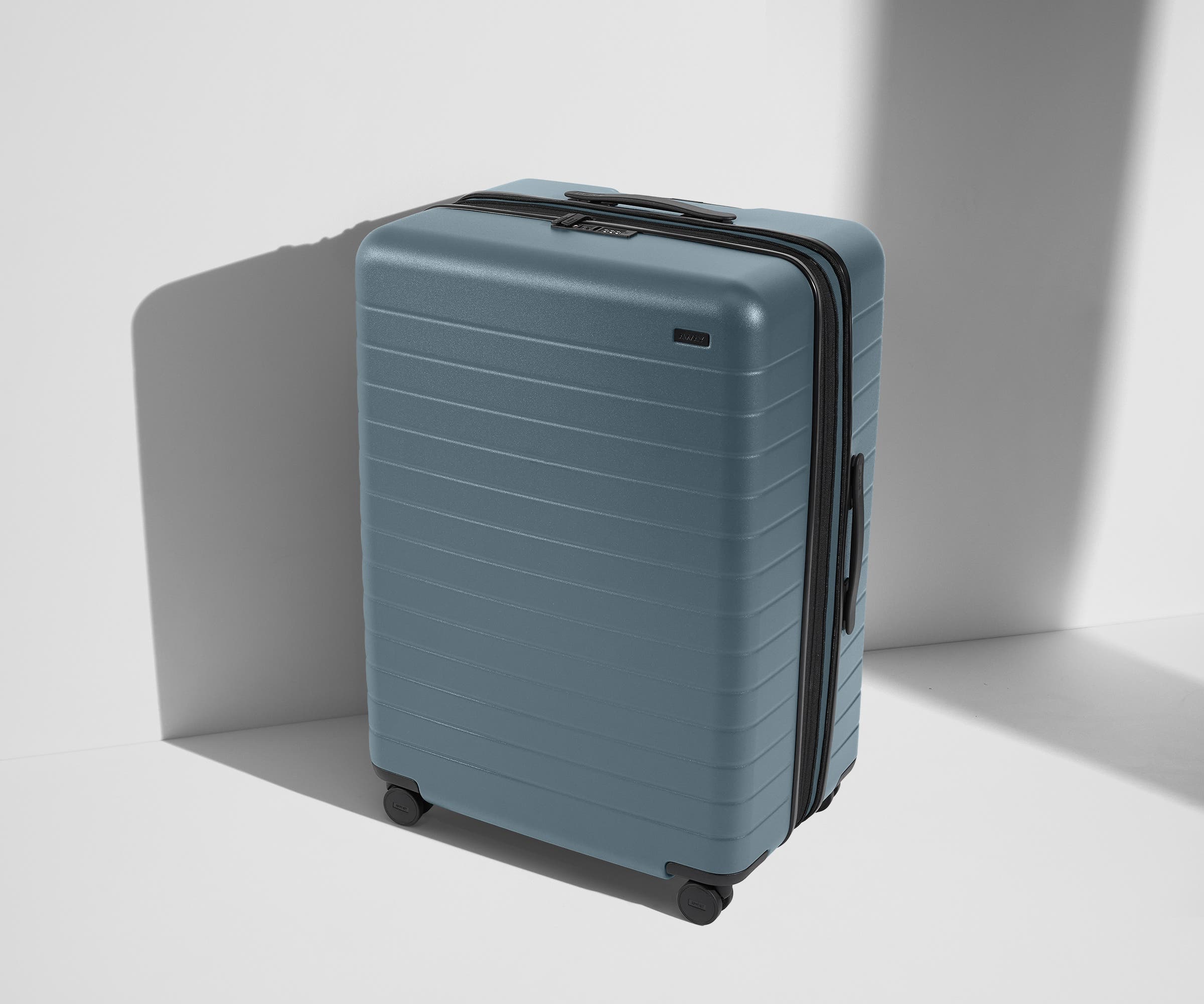 Angled product view of The Large Flex suitcase in Coast Blue