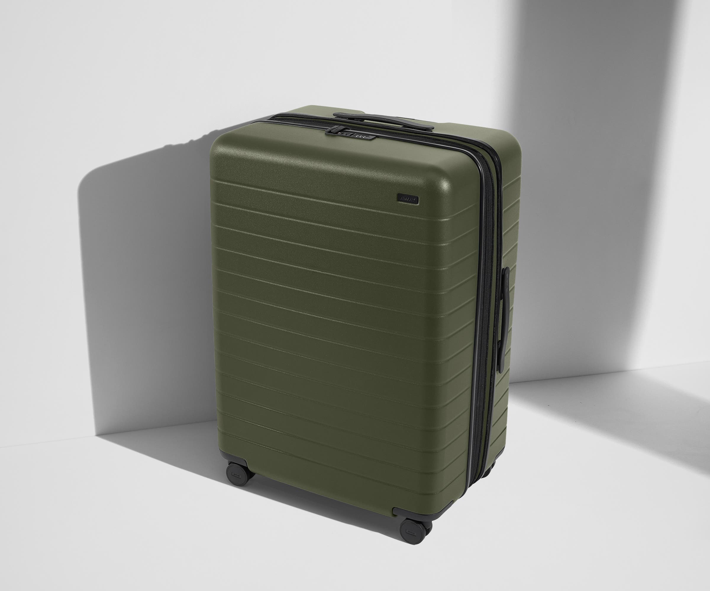 Angled product view of The Large Flex suitcase in Olive Green