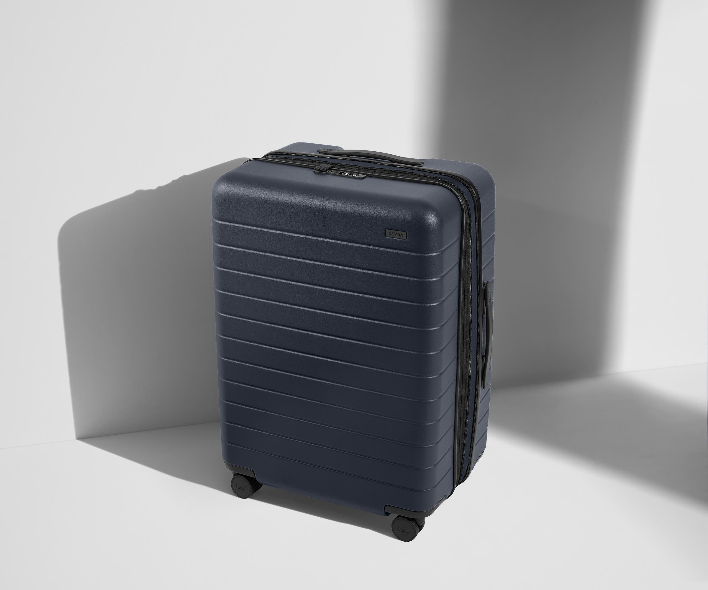 Angled product view of The Medium Flex suitcase in Navy Blue