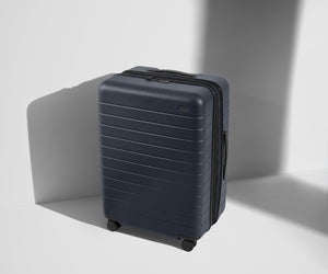 Angled product view of The Medium Flex suitcase in Navy Blue