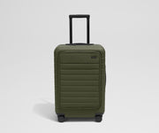 Front product view of The Front Pocket Bigger Carry-On suitcase in Olive Green with raised handle