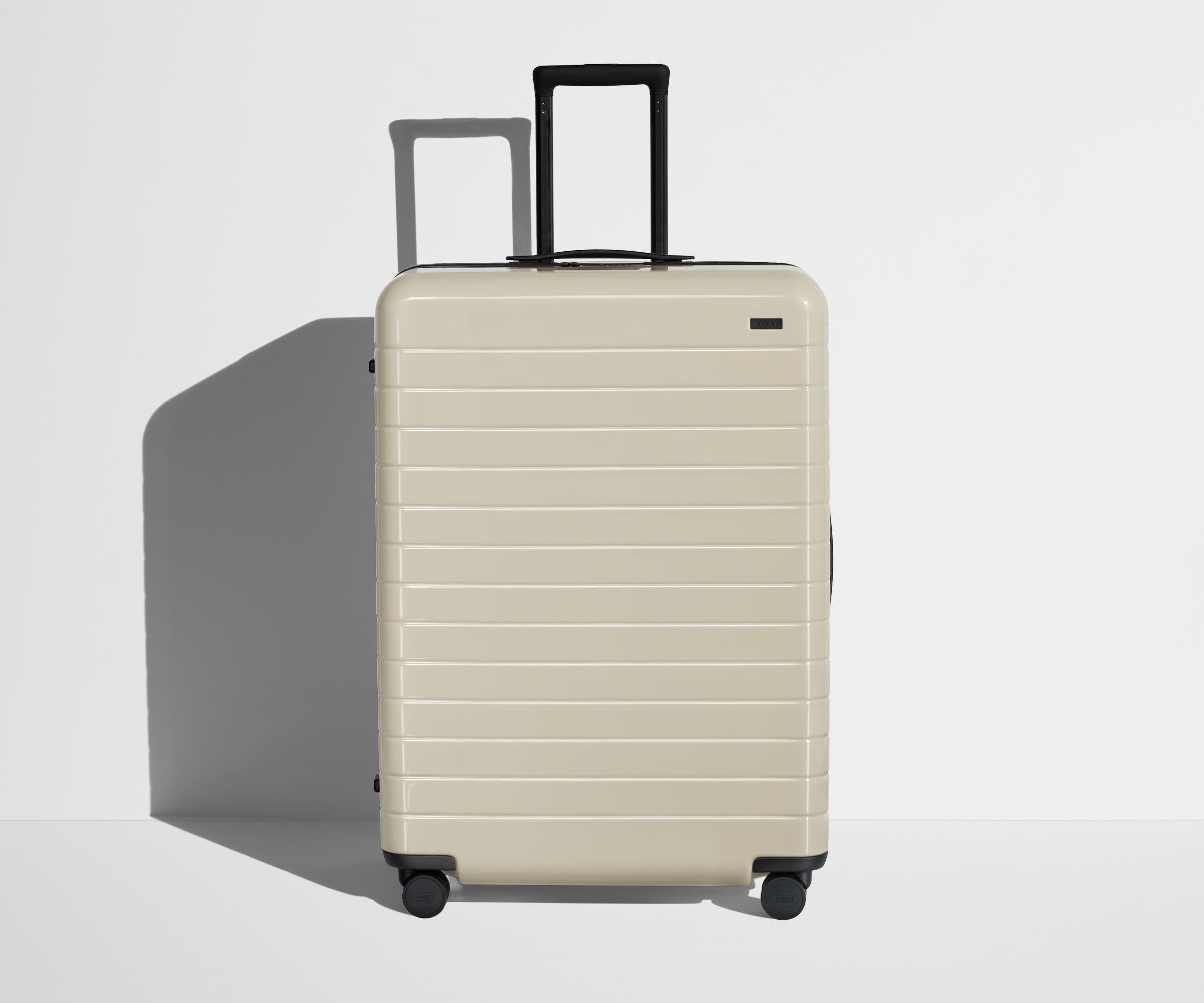 Front product view of The Large suitcase in Salt White (Gloss) with raised handle