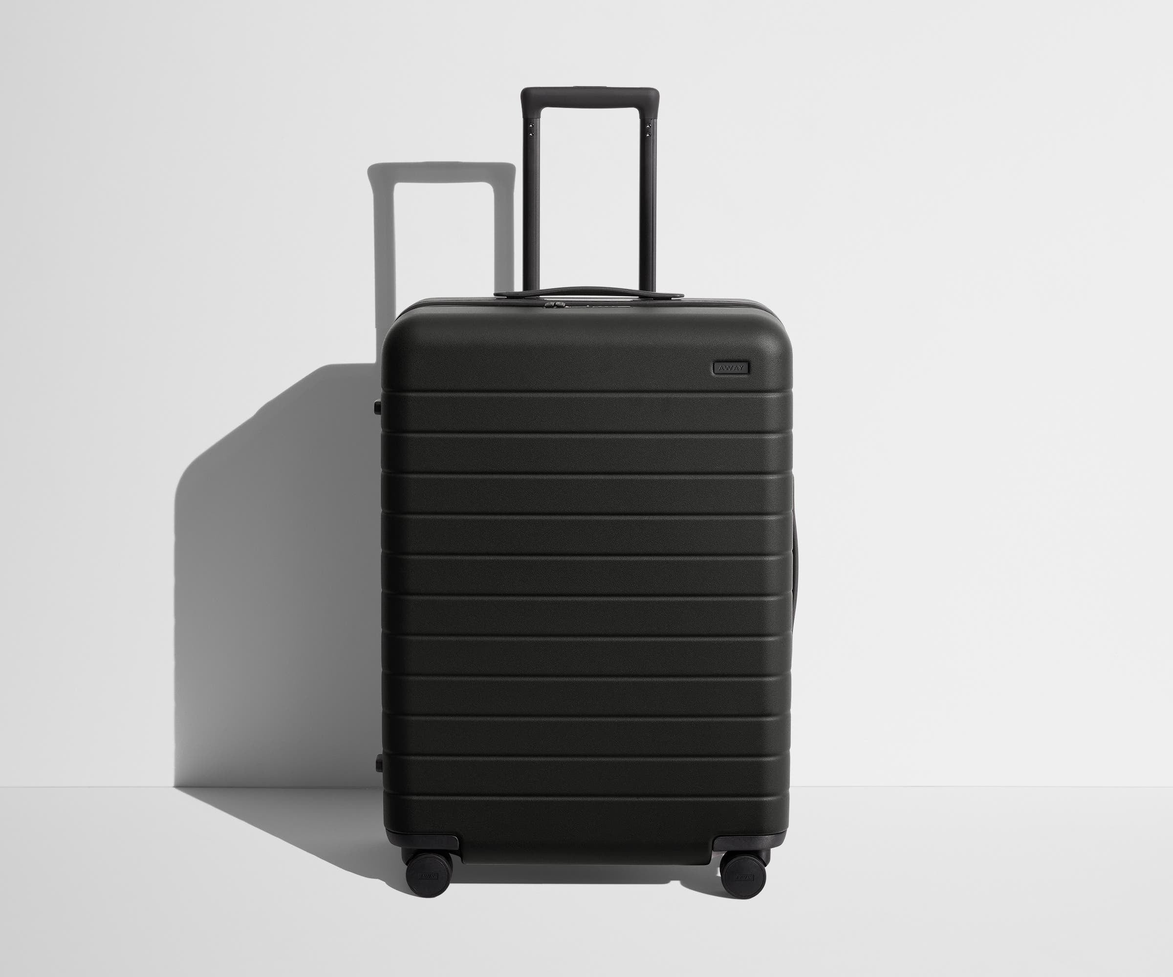 Front product view of The Medium suitcase in Jet Black with raised handle