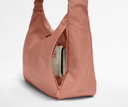 Passport shown in the travel-ready pocket in the front zippered pocket