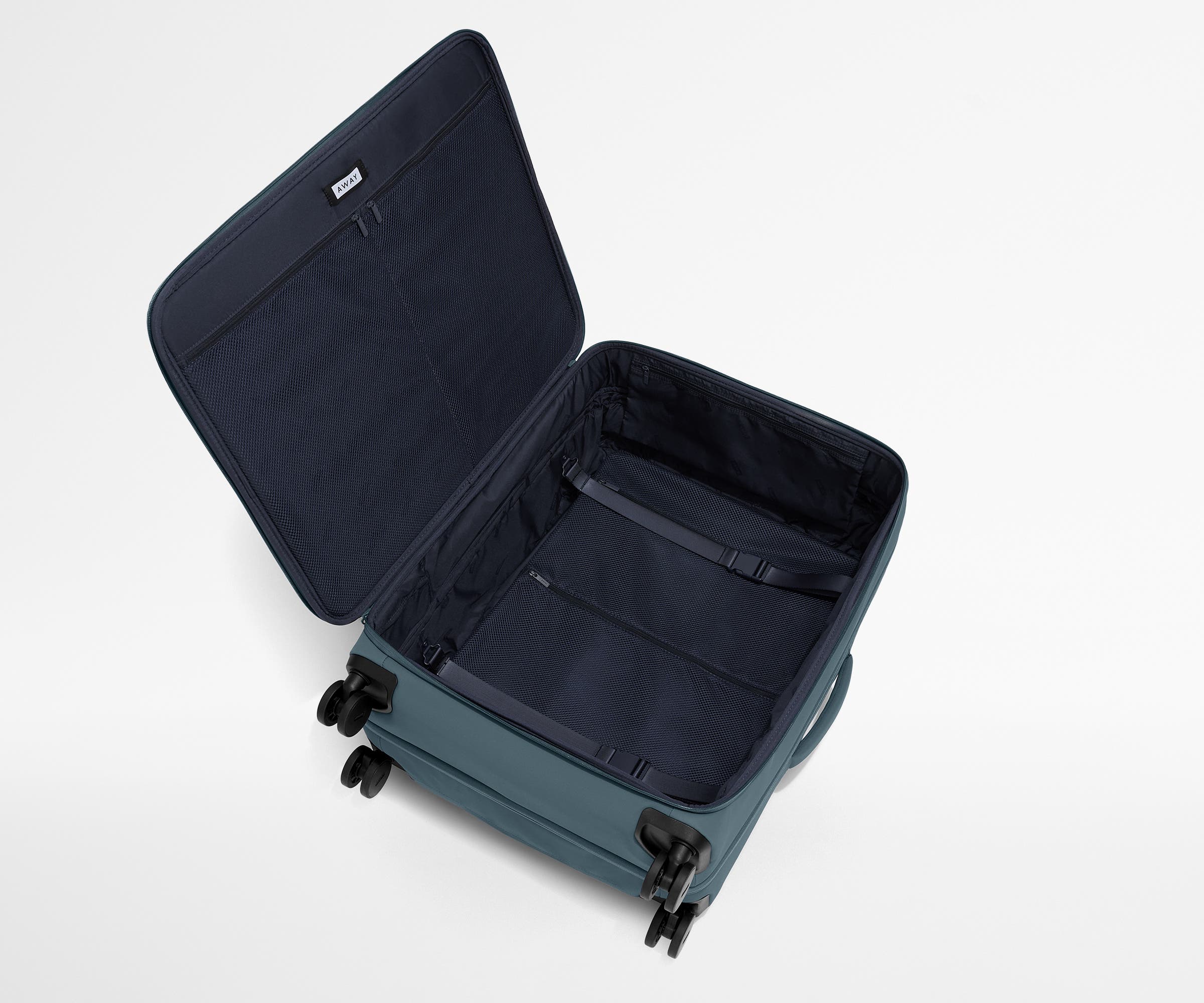 Open, unpacked Softside Large suitcase, showing the depth of the bag and signature compression pad feature