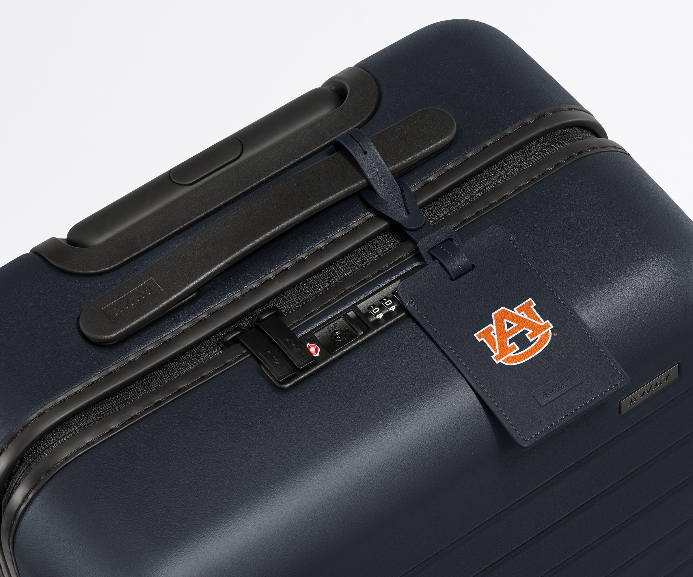 Auburn University ® Collegiate Luggage Tag on top of a matching Auburn University ® Bigger Carry-On