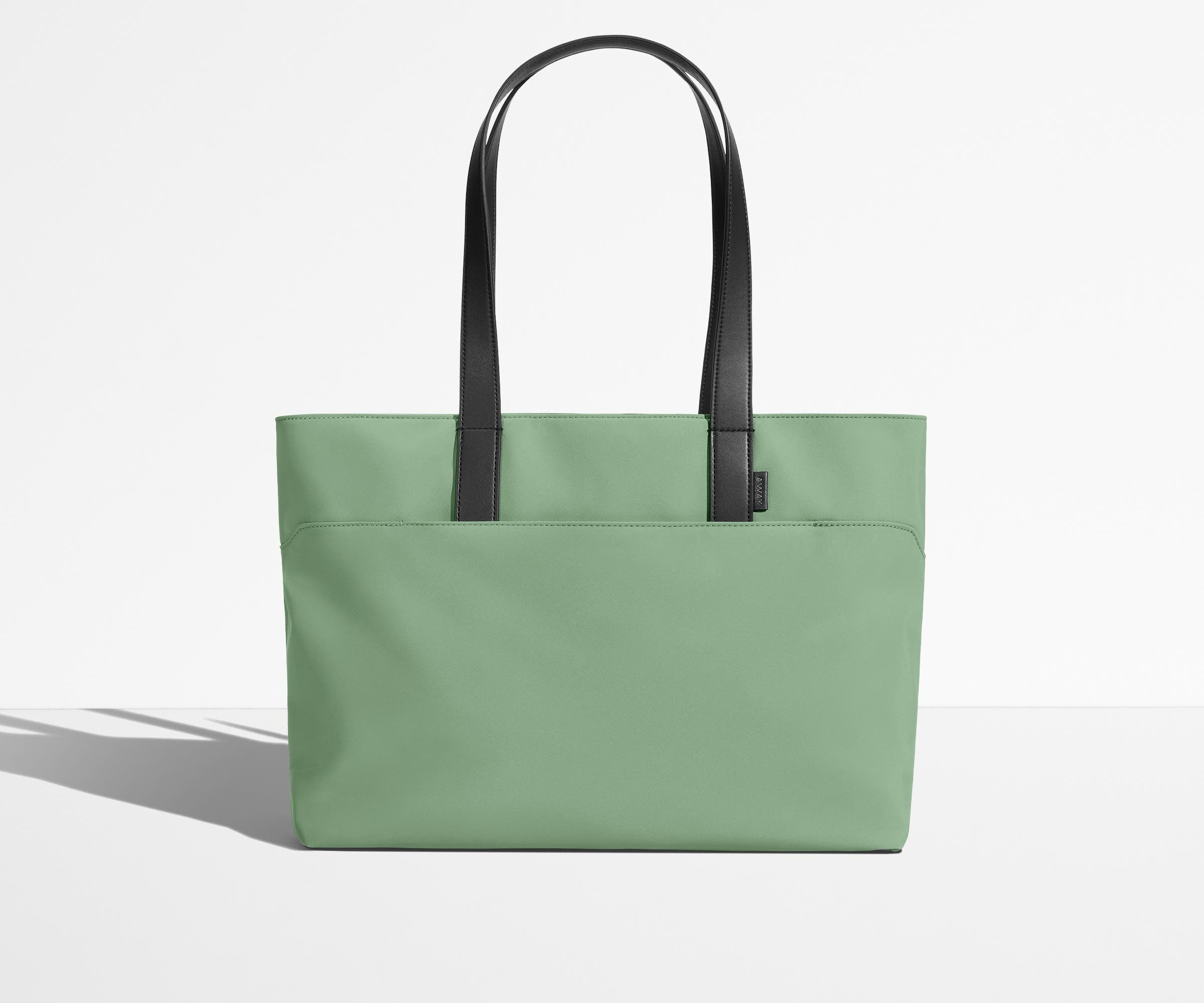 Front view of The Everywhere Tote with its leather handles up