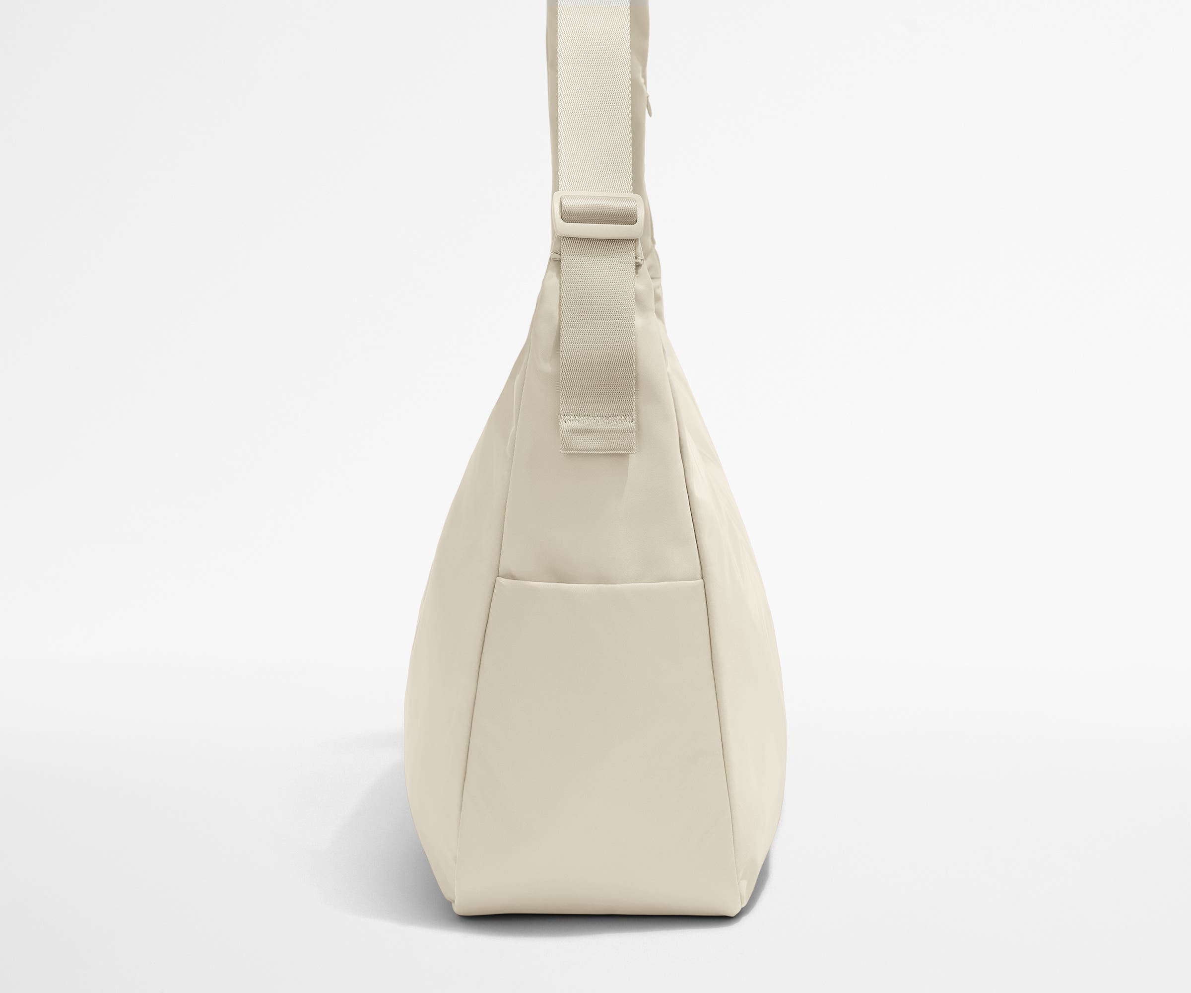 Side view of the Large Featherlight Crossbody showing the exterior bottle pocket