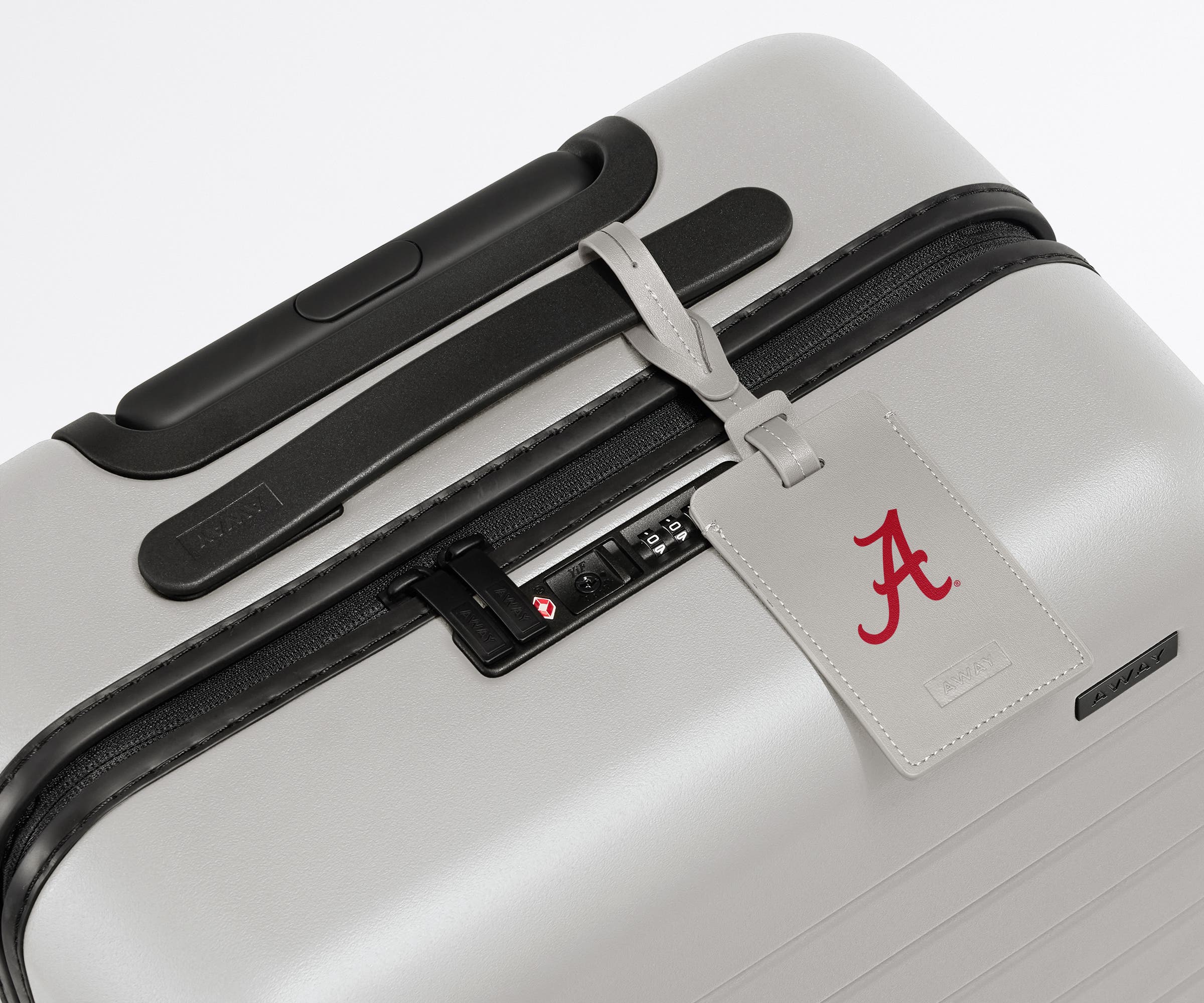 The University of Alabama ® Collegiate Luggage Tag on a matching The University of Alabama ® Bigger Carry-On suitcase