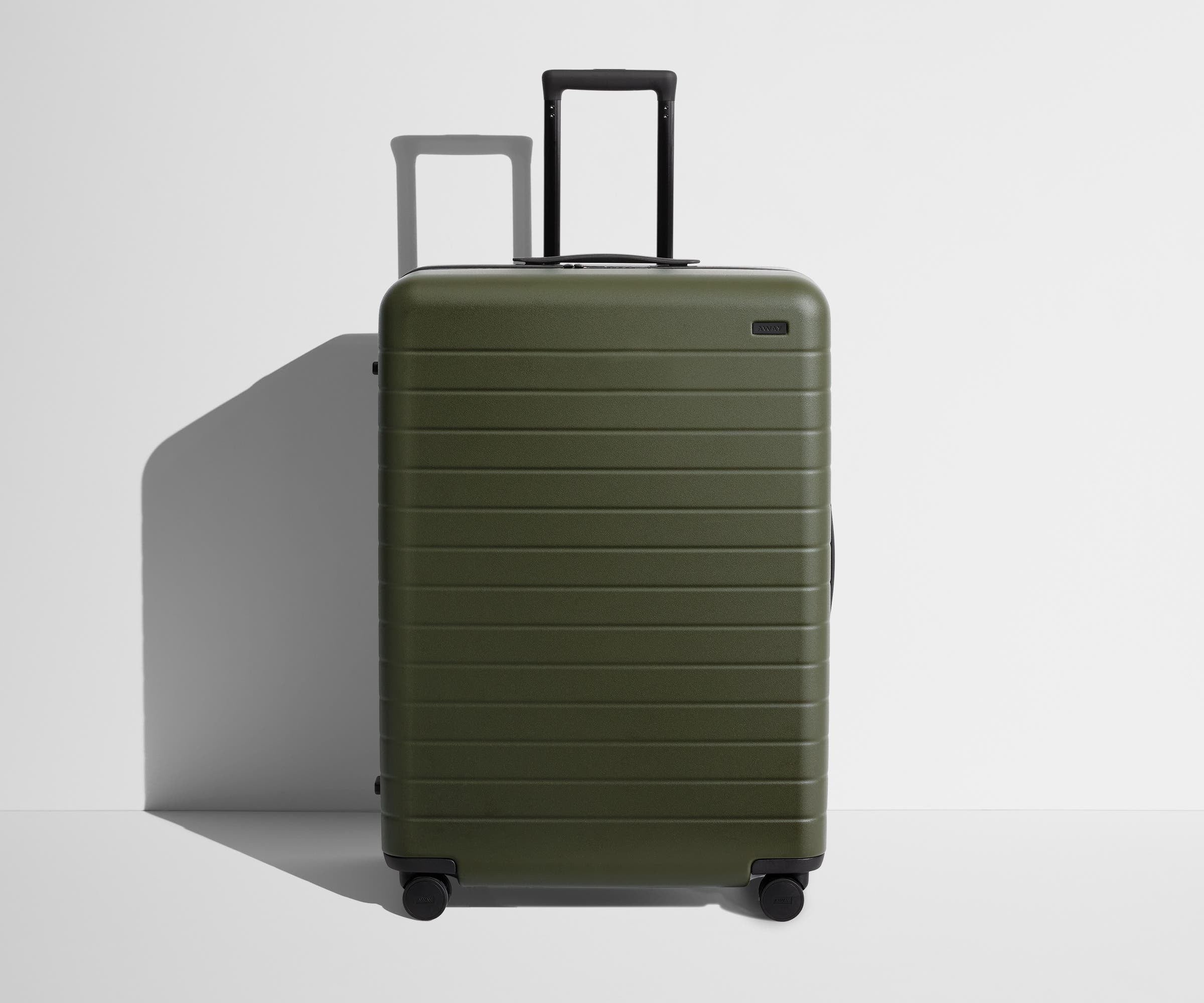 Front product view of The Large suitcase in Olive Green with raised handle